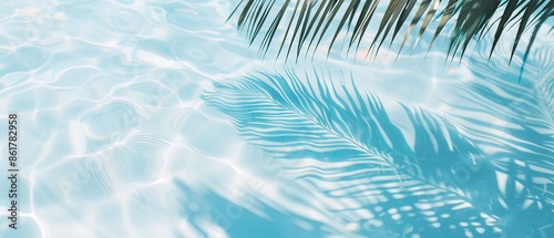 Elegant minimalist background concept featuring close-up water surface with gentle ripples and subtle blurred palm leaf shadows on the beach, evoking a peaceful, natural and pure atmosphere. © Kava