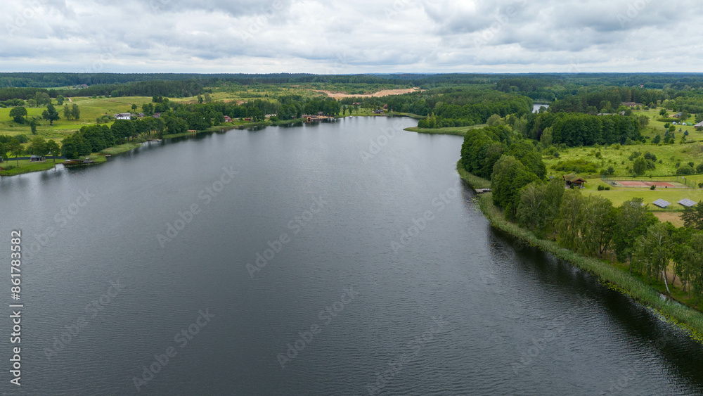 Drone photography of lake, forest and houses near it during summer day Drone photography of lake, forest and houses near it during summer day