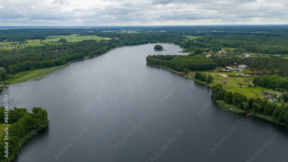 Drone photography of lake, forest and houses near it during summer day Drone photography of lake, forest and houses near it during summer day