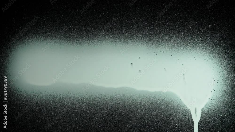 Person using graffiti spray white paint and drawing directly on black glass screen isolated background, opposite view scene.