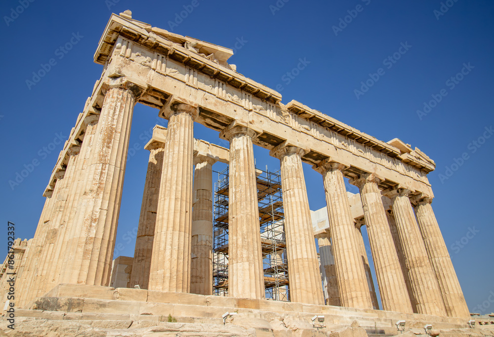Ancient Parthenon Temple on top of the Acropolis Athens, Greece at sunny day with a blue sky. The landmark of Athens. Parthenon is the temple of for dedication to the goddess Athena. Ancient Parthenon Temple on top of the Acropolis Athens, Greece at sunny day with a blue sky. The landmark of Athens. Parthenon is the temple of for dedication to the goddess Athena.