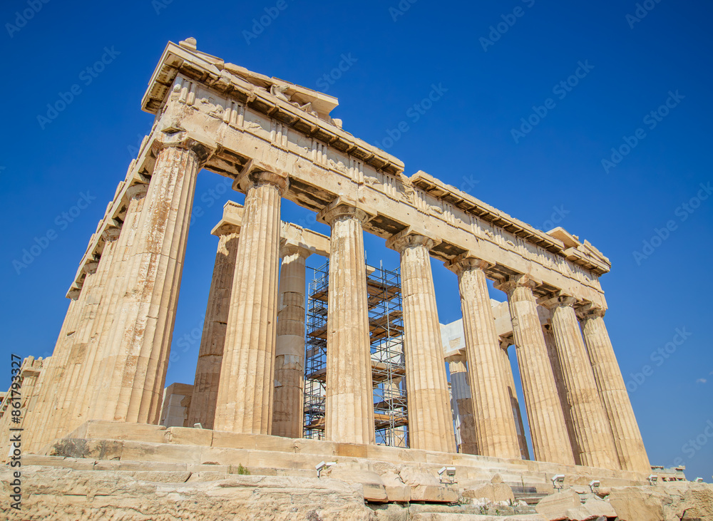 Ancient Parthenon Temple on top of the Acropolis Athens, Greece at sunny day with a blue sky. The landmark of Athens. Parthenon is the temple of for dedication to the goddess Athena. Ancient Parthenon Temple on top of the Acropolis Athens, Greece at sunny day with a blue sky. The landmark of Athens. Parthenon is the temple of for dedication to the goddess Athena.