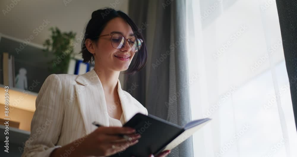Joyful Smiling Businesswoman Writing in Notebook Joyful Smiling Businesswoman Writing in Notebook