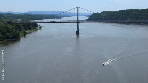 boat sailing on the hudson river with view of mid hudson bridge and distant mountains in the valley (landscape suspension transport road cars) summer leisure
