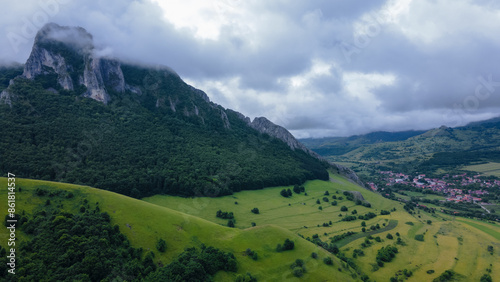 Aerial photo of the rural settlement of Rimetea, Romania. Photography was shoot from a drone with camera level for a panoramic view of the village through the mountains.