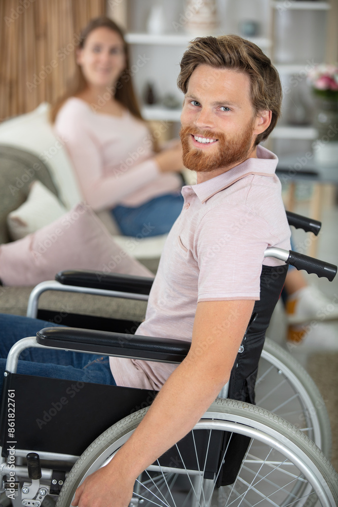 cheerful woman lying on sofa with disabled man cheerful woman lying on sofa with disabled man