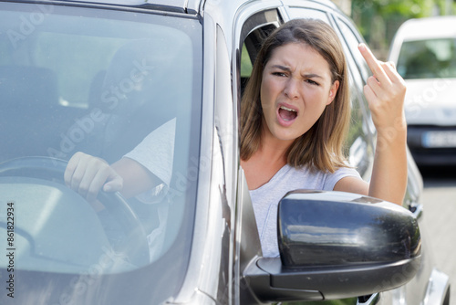 woman shows obscene gesture from a car