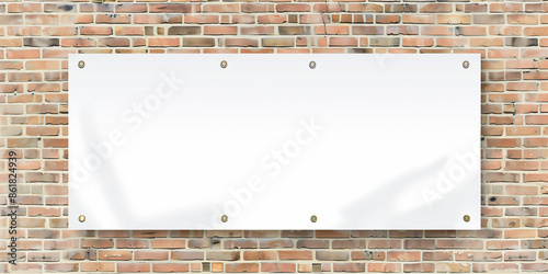 A blank white shiny pvc tarpaulin banner hanging on brick wall