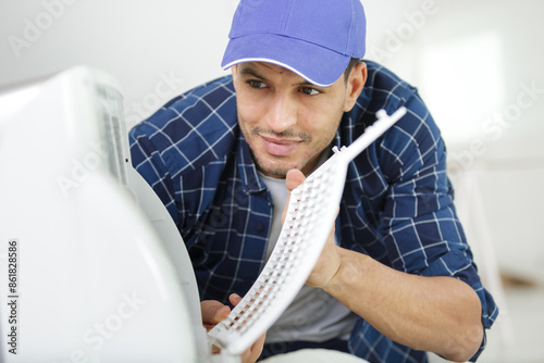 installation service by technican worker checking the air filter photo