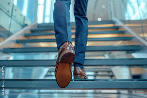 A man wearing brown shoes and brown pants is walking up a set of stairs