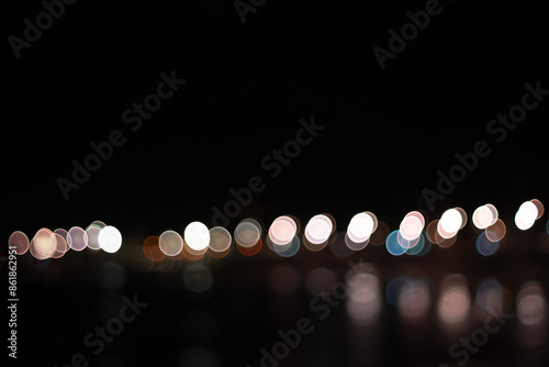 Lights out of focus against a dark background, creating an effect known as bokeh