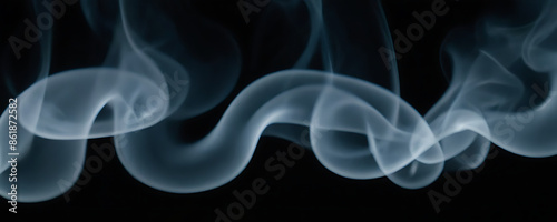 Wispy trails of blue-gray smoke curling against a dark background. Perfect for creating a sense of mystery, atmosphere, or intrigue in designs.