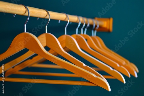 A row of wooden hangers on a rack. photo