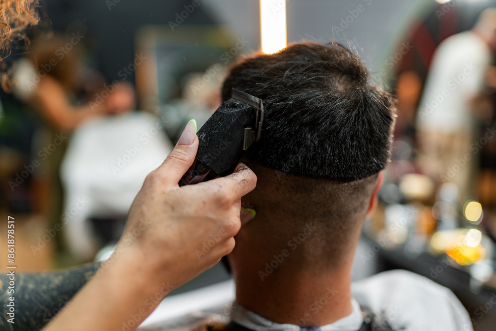 Close-up view of a female barber's hands expertly using clippers to perfect a male client's haircut, focusing on detail and craftsmanship in a stylish barber shop Close-up view of a female barber's hands expertly using clippers to perfect a male client's haircut, focusing on detail and craftsmanship in a stylish barber shop