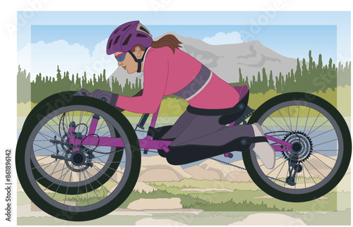 para sports adaptive off-road mountain biking, female cyclist with a physical disability kneeling forward in a recumbent 3-wheel handcycle on a trail with an outdoor background
