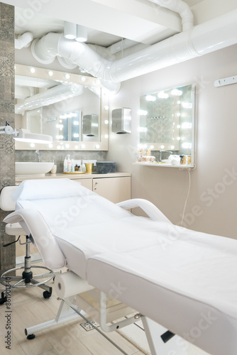 Beauty cabinet with cosmetology couch and modern interior in light tones.