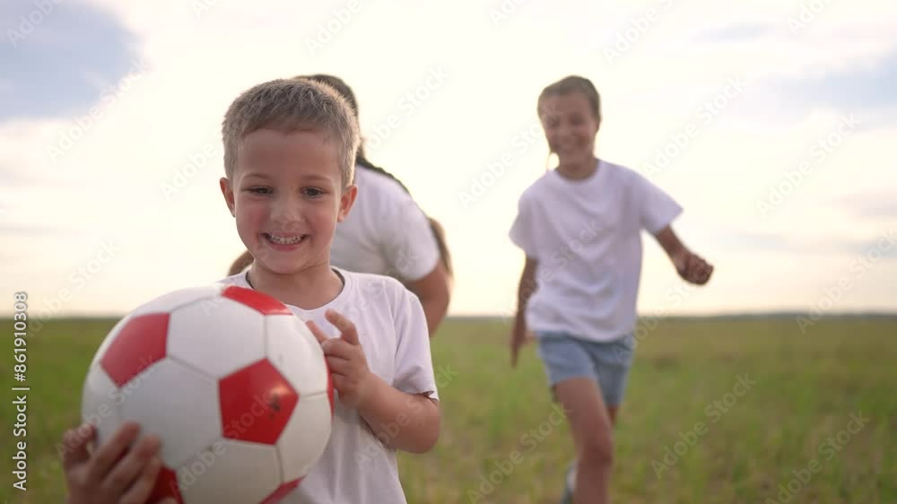 Group of children playing together with a ball. Child summer soccer concept. group of children are running around in a park with a ball. Group of children playing together in fun a park while running. Group of children playing together with a ball. Child summer soccer concept. group of children are running around in a park with a ball. Group of children playing together in fun a park while running.