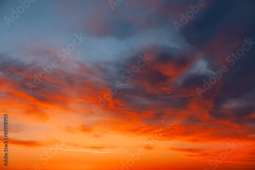 Fototapeta Naklejka Na Ścianę i Meble -   Scenic sunset with clouds in a colorful sky. Beautiful orange and blue sky with clouds. Heaven is filled with clouds and the sun is setting