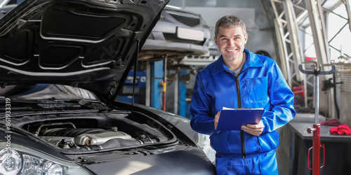 Male mechanic with clipboar...