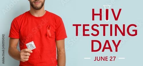 Banner for National HIV Testing Day with young man holding condom photo