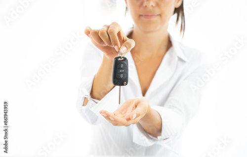 A woman is holding a car key in her hand