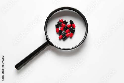 Magnifier with pills on gre...