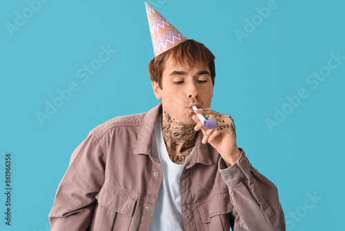 Young man with party whistl...