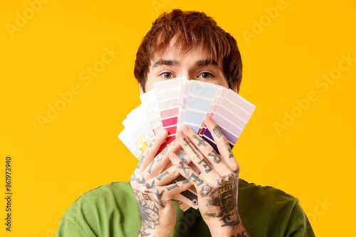 Young man covering face wit...