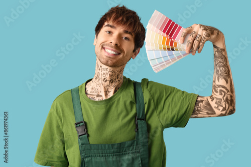 Male painter holding differ...