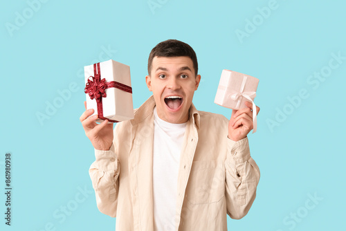 Handsome man with gift boxe...