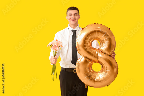 Handsome man holding balloo...