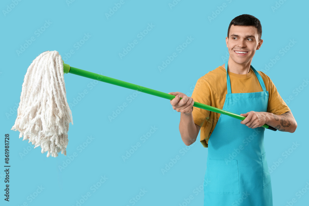 Male janitor with floor mop on blue background Male janitor with floor mop on blue background