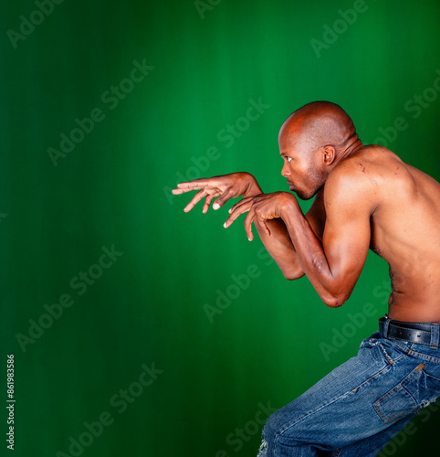 Konstfotografi african american young man lurking in the dark, wounds on the bare torso