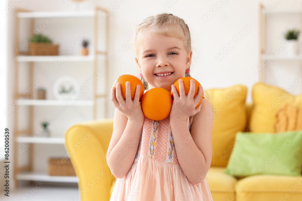 Cute little girl with oranges at home Cute little girl with oranges at home