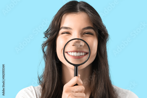 Smiling young woman magnify...