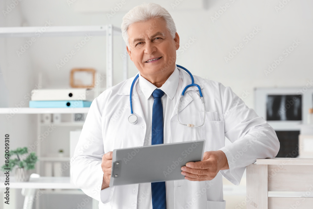 Mature doctor with clipboard working in clinic Mature doctor with clipboard working in clinic