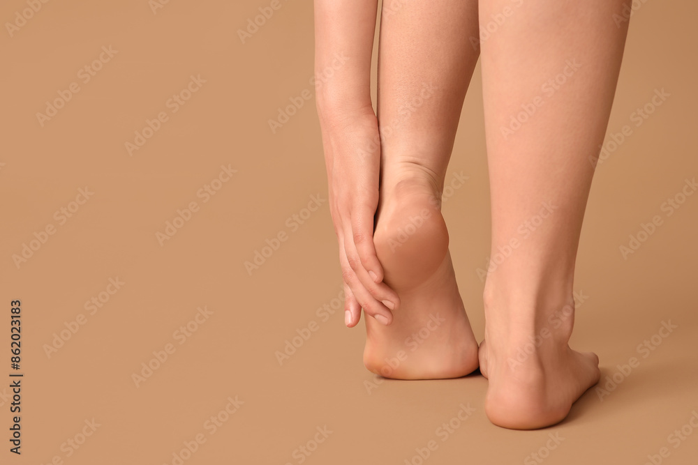 Legs of pretty young woman on beige background Legs of pretty young woman on beige background