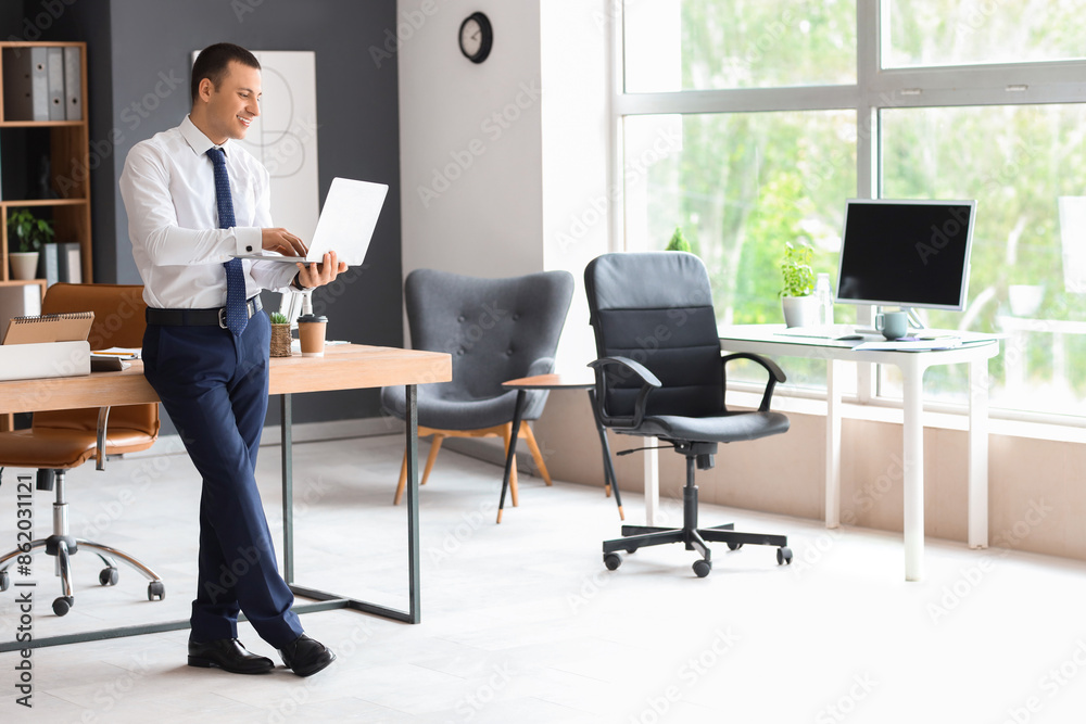 Male accountant working with laptop in office Male accountant working with laptop in office