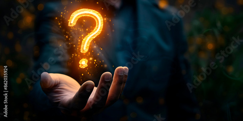 A hand holding a glowing question mark. Concept of curiosity and wonder, as the question mark is lit up and he is floating in the air