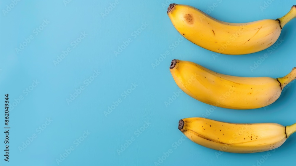 Top view of ripe bananas on a blue background with empty space Top view of ripe bananas on a blue background with empty space
