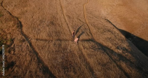 Male and female ballet dancer doing contempoary dance on dry grassy hills in Mt Tamalpais as sunset. San Francisco, California, United States of America. photo