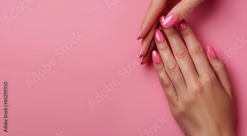 Female Hand With Pink Nail Polish on Pink Background