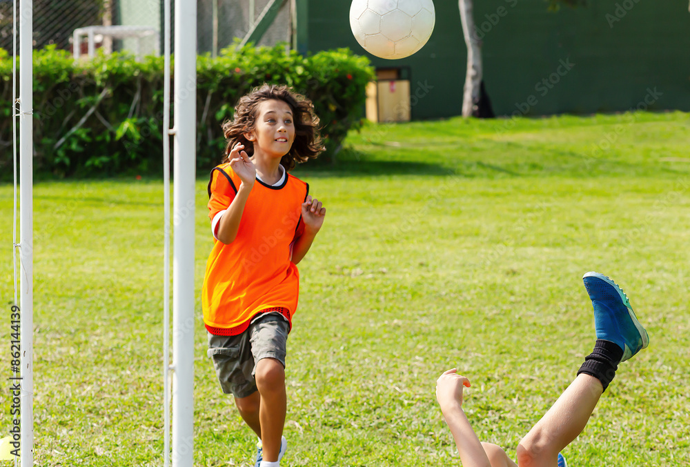 Obraz premium Youth Soccer Match with Colorful Training Bibs