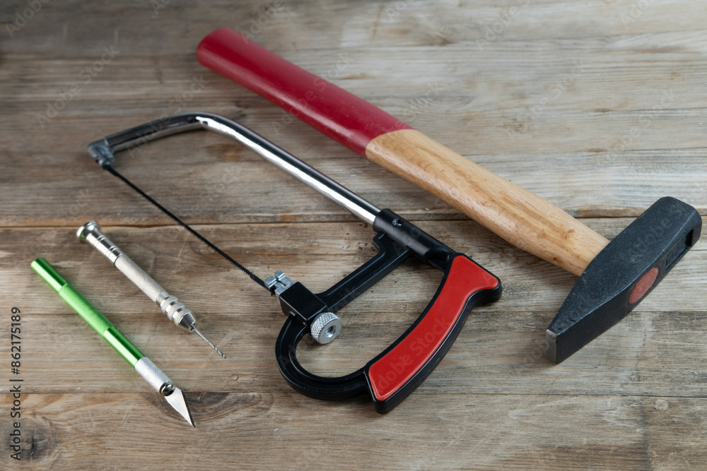 Creative project crafting hand tools jigsaw, knife and drill arranged on workbench, crafting essentials Creative project crafting hand tools jigsaw, knife and drill arranged on workbench, crafting essentials