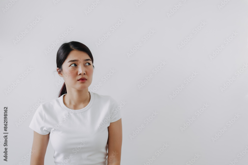 Asian Thai woman doubt and curious face, have question thinking and looking at empty space, isolated on white background wall. Asian Thai woman doubt and curious face, have question thinking and looking at empty space, isolated on white background wall.