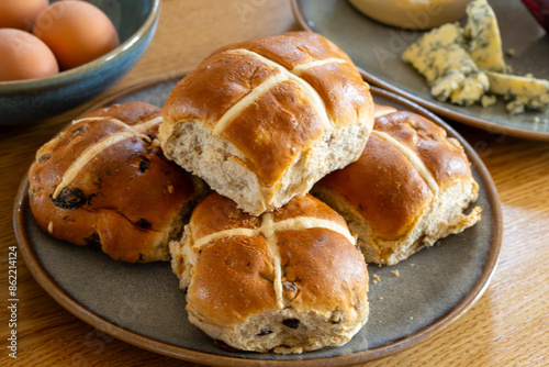 Traditional British Easter food, fresh baked cross buns with raisins or apples