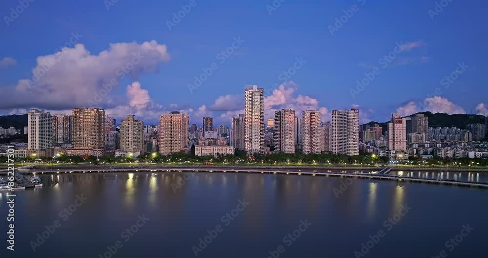 Aerial view of beautiful coastline with modern city buildings scenery at night in Zhuhai, Guangdong Province, China. Famous travel destination. Aerial view of beautiful coastline with modern city buildings scenery at night in Zhuhai, Guangdong Province, China. Famous travel destination.
