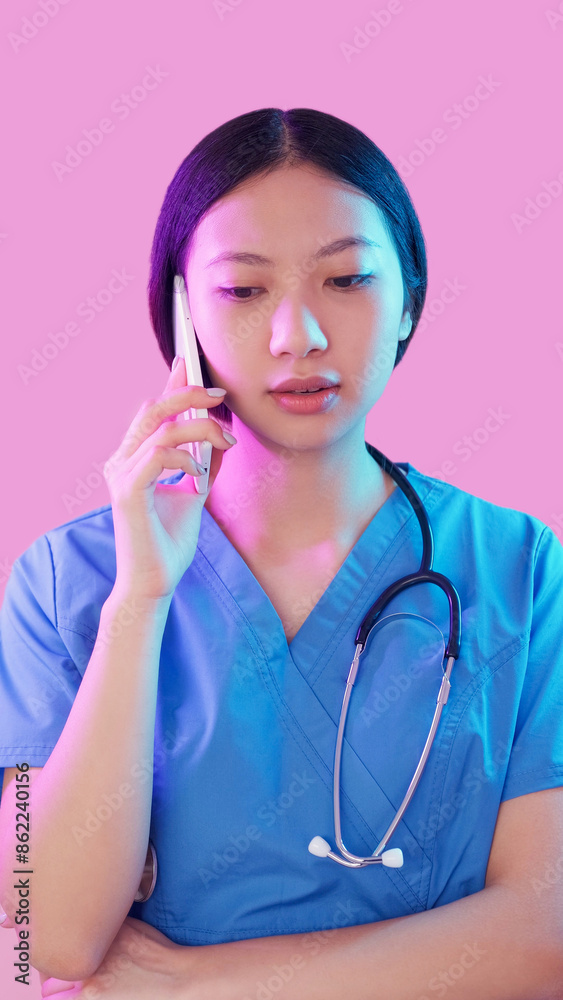 Mobile doctor. Medical call. Healthcare checkup. Neon light woman practitioner speaking to patient discussing diagnosis on phone isolated on pink. Mobile doctor. Medical call. Healthcare checkup. Neon light woman practitioner speaking to patient discussing diagnosis on phone isolated on pink.