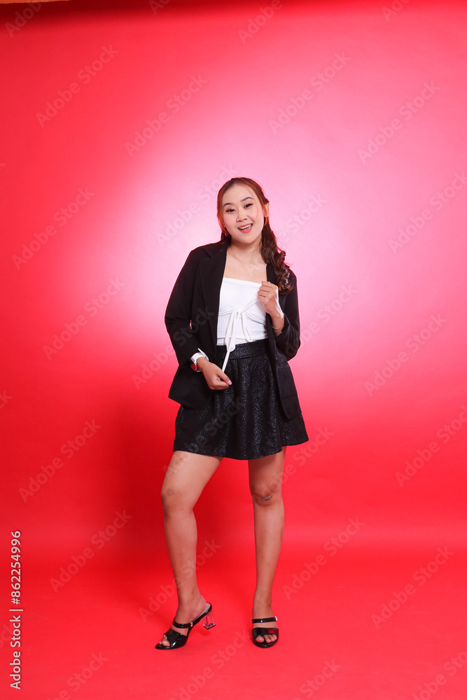 full portrait of Asian woman in career office standing cheerfully wearing black suit holding white tank top, for company, fashion, commercial, agency full portrait of Asian woman in career office standing cheerfully wearing black suit holding white tank top, for company, fashion, commercial, agency