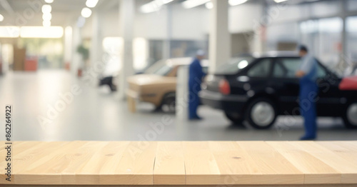 Wooden table, bench top with blurred car service, auto repair workshop © PREM